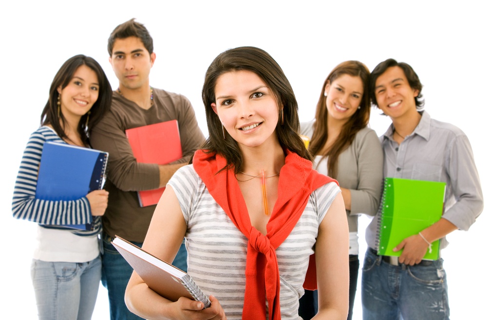 Group Leader smiling in front of a group of students over a white background