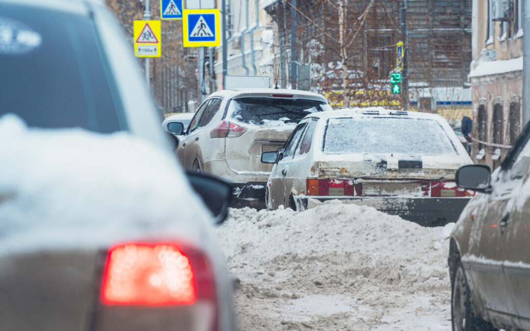 Cars on a snowy city street when there is lot of snow