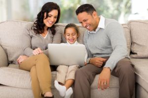 happy family using laptop in living room